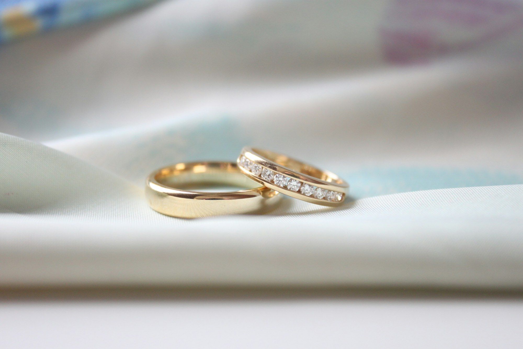 Two gold wedding bands, one plain and one set with diamonds