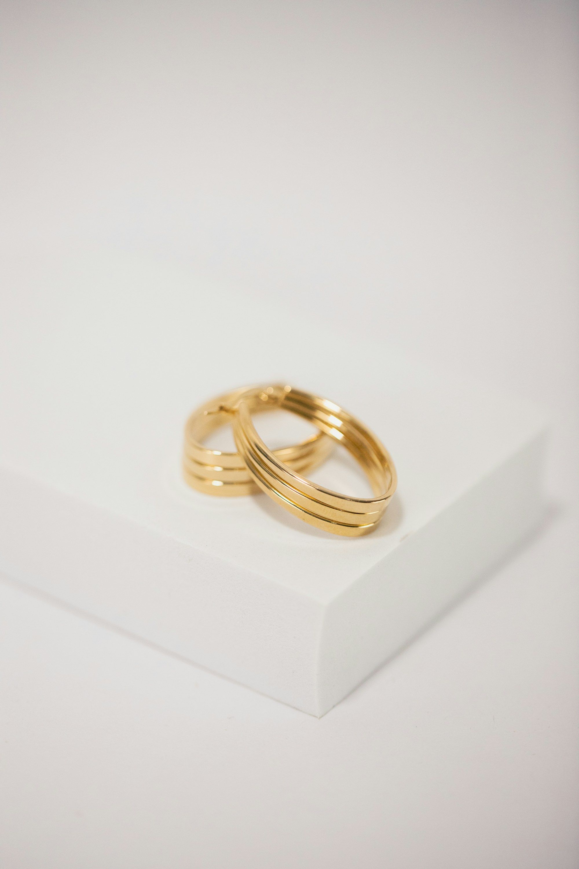 Stack of gold rings on a white block