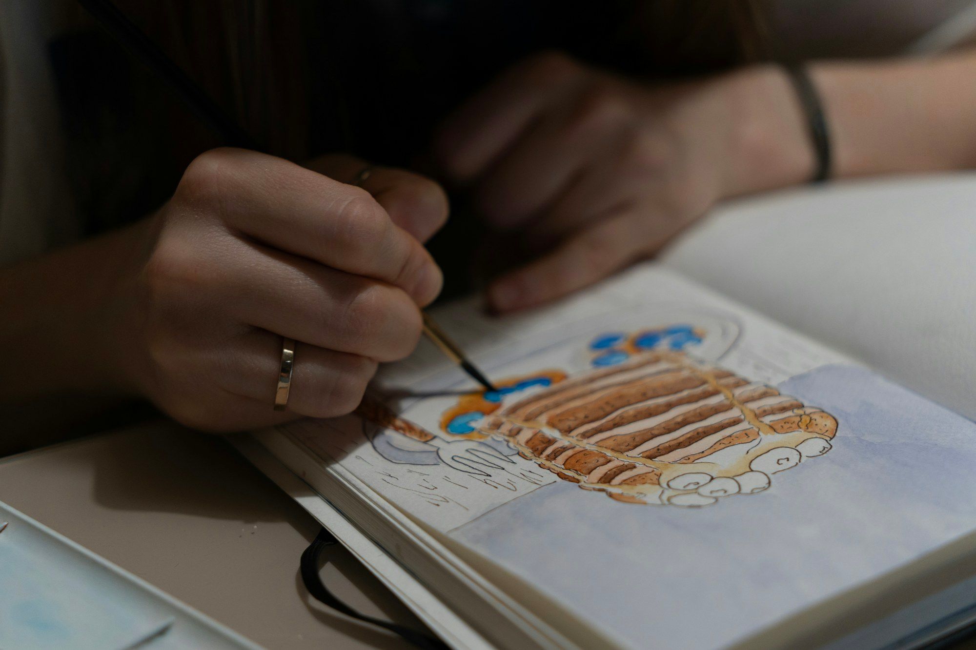 Hand painting a jewellery design in gouache