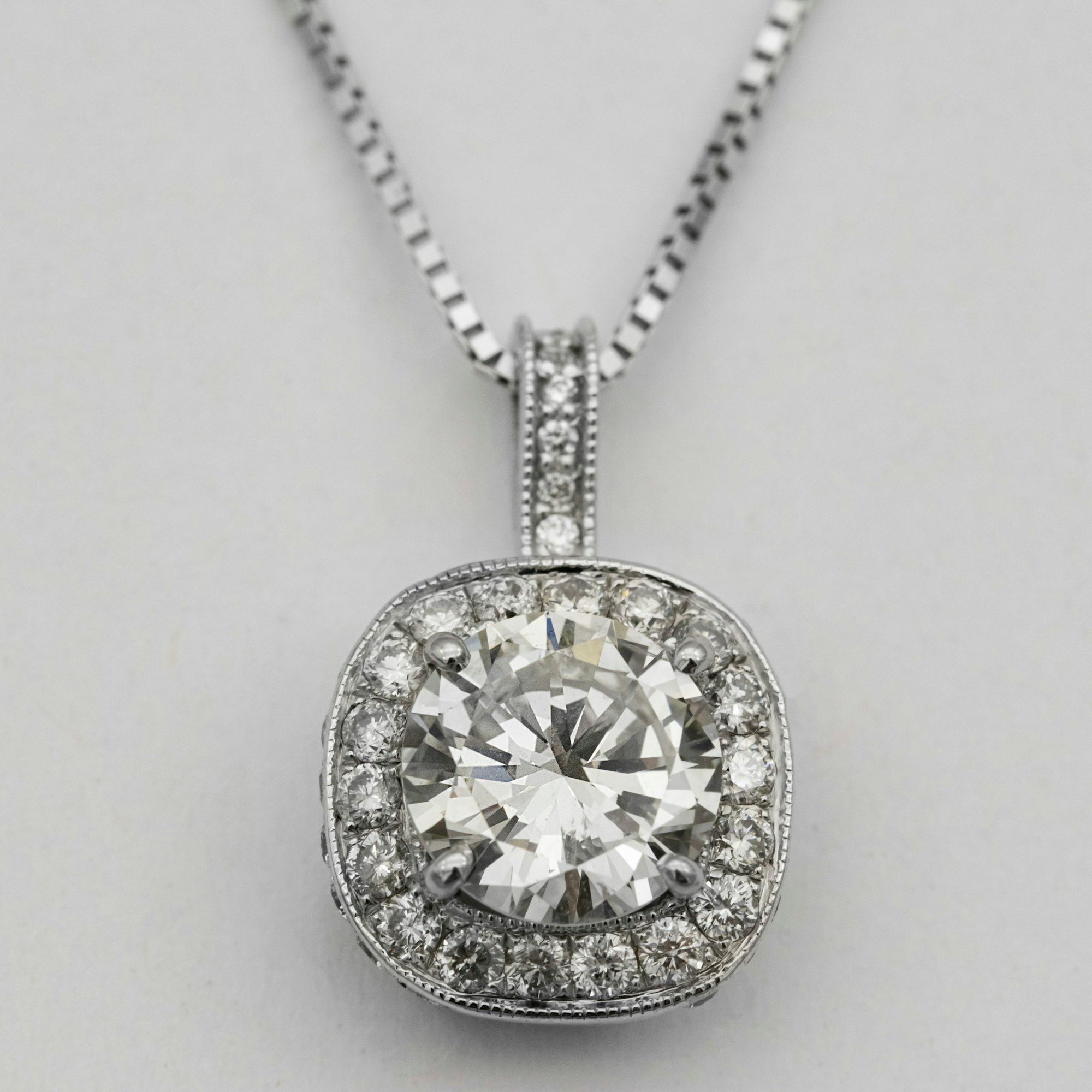 Cushion halo diamond pendant on a white gold chain